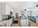 Modern kitchen featuring white cabinetry, black countertops, and stainless steel appliances at 497 Rotonda Cir, Rotonda West, FL 33947
