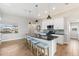 Bright kitchen featuring a large island with bar seating, stainless steel appliances, and wood-look tile floors at 497 Rotonda Cir, Rotonda West, FL 33947