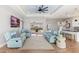 Spacious living room with comfortable seating, a ceiling fan, and seamless access to outdoor living at 497 Rotonda Cir, Rotonda West, FL 33947