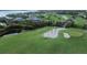 Picturesque golf course view with pond, sand traps and lush greenery near coastal houses at 6800 Placida Rd # 235, Englewood, FL 34224