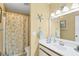 Bathroom with seashell themed shower curtain, matching decor and vanity at 6800 Placida Rd # 235, Englewood, FL 34224