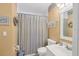 Bathroom featuring tan walls, a framed print, and a shower with a striped curtain at 6800 Placida Rd # 235, Englewood, FL 34224