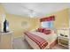 Bedroom featuring yellow walls, a ceiling fan, and a white wicker bed at 6800 Placida Rd # 235, Englewood, FL 34224