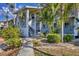 Inviting two-story home with a well-maintained walkway, landscaped yard, and charming tropical foliage at 6800 Placida Rd # 235, Englewood, FL 34224