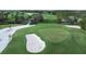 Scenic aerial view of a golf course with a sand trap and manicured green at 6800 Placida Rd # 235, Englewood, FL 34224