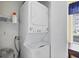 Convenient laundry area with a stacked washer and dryer, maximizing space and functionality for easy laundry tasks at 6800 Placida Rd # 235, Englewood, FL 34224