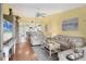 Living room featuring hardwood floors, furniture, ceiling fan, and views into the kitchen at 6800 Placida Rd # 235, Englewood, FL 34224