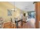Cozy living room with hardwood floors, ceiling fan, and access to an outdoor balcony at 6800 Placida Rd # 235, Englewood, FL 34224