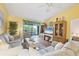 Comfortable living room featuring hardwood floors, ceiling fan, and sliding glass doors to a balcony at 6800 Placida Rd # 235, Englewood, FL 34224