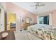 Spacious main bedroom featuring light pink walls, a ceiling fan, and a sliding glass door at 6800 Placida Rd # 235, Englewood, FL 34224