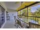 Relaxing screened patio with comfortable seating, perfect for enjoying outdoor views and dining al fresco in comfort at 6800 Placida Rd # 235, Englewood, FL 34224