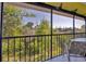 Serene view from screened patio overlooking lush greenery, offering a tranquil escape and connection with nature at 6800 Placida Rd # 235, Englewood, FL 34224