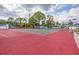 Well-maintained tennis court surrounded by lush landscaping, offering a scenic spot for active recreation and sports at 6800 Placida Rd # 235, Englewood, FL 34224