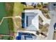 Aerial of home with private dock, tropical landscaping and concrete driveway, and a metal roof at 7180 Brittany Cir, Englewood, FL 34224