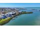 An aerial view shows the home nestled along the waterfront with lush surroundings at 7180 Brittany Cir, Englewood, FL 34224