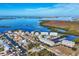 Aerial view showcases the property's prime waterfront location within a beautiful coastal community at 7180 Brittany Cir, Englewood, FL 34224