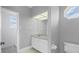 Bathroom with double vanity, large mirror and tile floors at 7180 Brittany Cir, Englewood, FL 34224