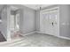 Bright foyer with decorative glass front door and tile floors at 7180 Brittany Cir, Englewood, FL 34224