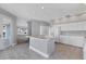 Bright kitchen featuring an island, white cabinets and tile floors at 7180 Brittany Cir, Englewood, FL 34224