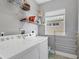 Functional laundry room with washer, dryer, shelving and window at 7180 Brittany Cir, Englewood, FL 34224