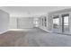Open-concept living room with access to kitchen and waterfront balcony at 7180 Brittany Cir, Englewood, FL 34224