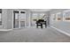 Large living room with a piano, water views and access to the patio at 7180 Brittany Cir, Englewood, FL 34224