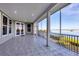Large tiled patio with screens and view of the water at 7180 Brittany Cir, Englewood, FL 34224