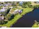 Lakeside home aerial shot with a stunning pool, showcasing its beautiful natural surroundings at 891 Harmony Ln, Englewood, FL 34223