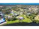An overhead view of a home with a pool in a lakeside community surrounded by mature trees at 891 Harmony Ln, Englewood, FL 34223