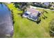 Aerial shot of a beautiful home with a screened pool and spacious backyard at 891 Harmony Ln, Englewood, FL 34223