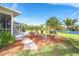 A beautiful backyard featuring a well-manicured lawn and relaxing seating areas at 891 Harmony Ln, Englewood, FL 34223