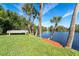 Backyard with a dock, boat, mature trees and waterfront views at 891 Harmony Ln, Englewood, FL 34223