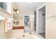 Well-lit bathroom featuring a vanity with a mirror and a separate room for the toilet and shower at 891 Harmony Ln, Englewood, FL 34223