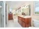 Bathroom with walk-in shower, soaking tub, vanity, and a window for natural light that creates a serene space at 891 Harmony Ln, Englewood, FL 34223