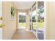 Tiled entryway leading to the front door with a screened porch at 891 Harmony Ln, Englewood, FL 34223