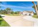 Spacious home with a large driveway, two-car garage, and well-manicured lawn at 891 Harmony Ln, Englewood, FL 34223