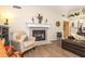 Elegant fireplace with decorative mantel, adding warmth and charm to the living space, with views to kitchen at 891 Harmony Ln, Englewood, FL 34223