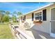 Charming front porch with flower boxes and seating area, enhancing the curb appeal of this inviting home at 891 Harmony Ln, Englewood, FL 34223