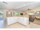 Open kitchen with granite counters and white cabinets, connecting to the living room, perfect for entertaining at 891 Harmony Ln, Englewood, FL 34223