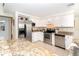 Well-equipped kitchen with stainless steel appliances, granite counters, and ample storage, designed for culinary enthusiasts at 891 Harmony Ln, Englewood, FL 34223