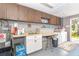 Functional laundry room with a sink, storage cabinets, washer, and dryer, offering convenience and practicality at 891 Harmony Ln, Englewood, FL 34223