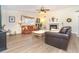 Cozy living room features wood-look floors, a fireplace, and comfortable seating, ideal for relaxation and gatherings at 891 Harmony Ln, Englewood, FL 34223