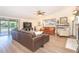 Bright living room with wood-look floors, access to the lanai, and fireplace creating a cozy atmosphere at 891 Harmony Ln, Englewood, FL 34223