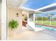 Screened-in patio that leads to a pool area, offering a seamless transition between indoor and outdoor living at 891 Harmony Ln, Englewood, FL 34223