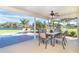 Spacious screened-in patio with beautiful lake views, offering comfortable seating and dining areas, and a peaceful retreat at 891 Harmony Ln, Englewood, FL 34223