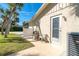 Back patio area with a table, chairs, and access to the yard, perfect for outdoor dining and relaxation at 891 Harmony Ln, Englewood, FL 34223