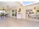An enclosed patio with access to the kitchen, dining, and living spaces, and a view of the outdoor space at 891 Harmony Ln, Englewood, FL 34223