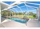 A screened pool with views of the backyard and lake at 891 Harmony Ln, Englewood, FL 34223