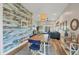 Stylish dining area featuring a wood accent wall, modern lighting, and an inviting atmosphere for Gathering gatherings at 10451 Sherman St, Englewood, FL 34224