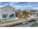 Gorgeous raised stilt home with a private pool, boat dock, and convenient outdoor bar area for entertaining at 10451 Sherman St, Englewood, FL 34224